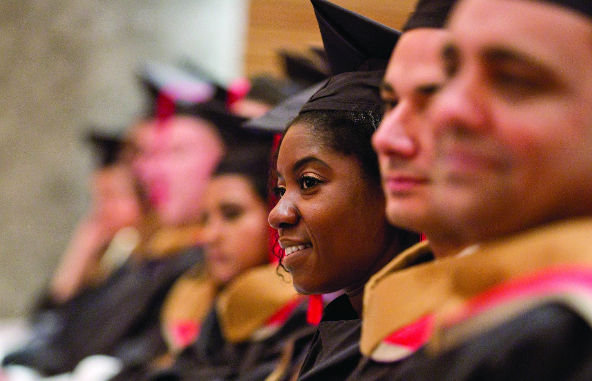 Sideview of graduates in cap and gowns during a convocation ceremony.