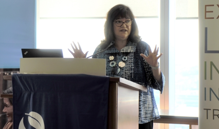 Anna Maria Ewing (MBA ’88) speaking at a podium during a Women in Business alumni event.