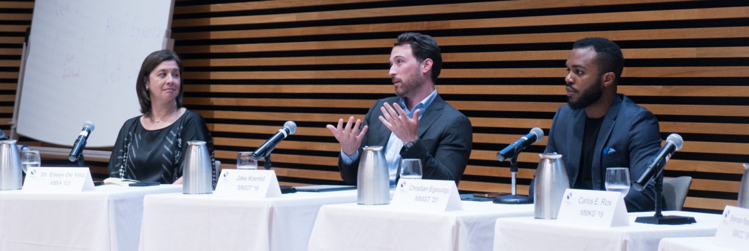 Three panelists in conversation during an alumni event.