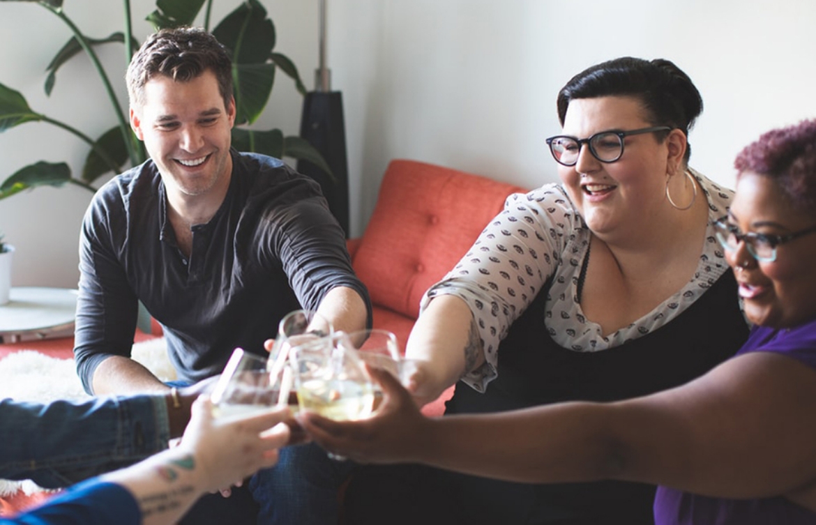 Group of happy people clinking glasses.