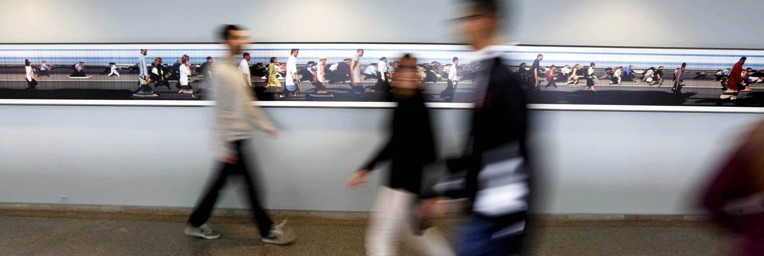 Students walking in a hallway at the Seymour Schulich Building.